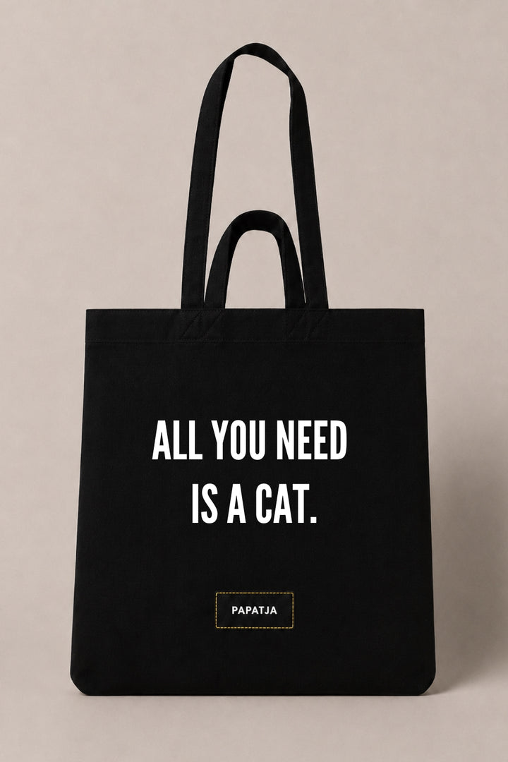 Black cotton PAPATJA tote bag with the quote All You Need Is a Cat, a lovely gift for cat lovers.