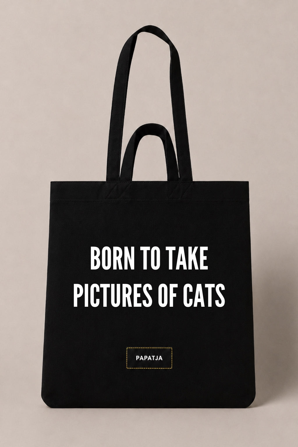 Black cotton PAPATJA tote bag with the quote Born to Take Pictures of Cats, a funny gift for cat lovers who love taking photos of their cat.