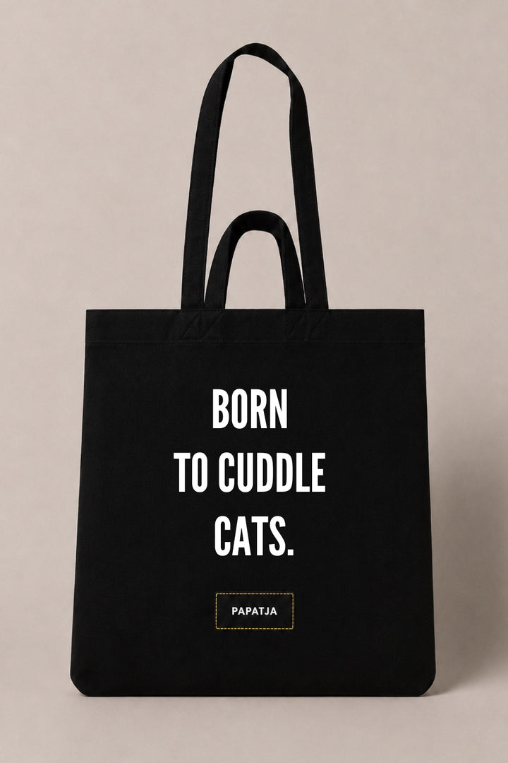 Black cotton PAPATJA tote bag with the quote Born to Cuddle Cats, a lovely gift for cat lovers who love cuddling their cat.