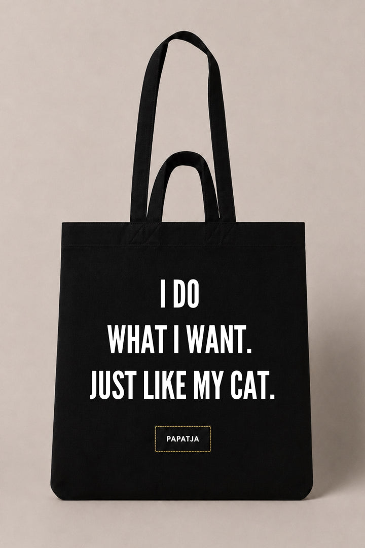 Black cotton PAPATJA tote bag with the quote I Do What I Want. Just Like My Cat, a funny gift for cat lovers.