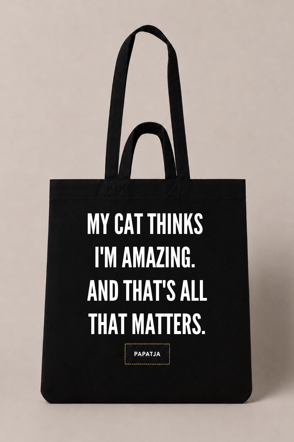 Black cotton PAPATJA tote bag with the quote My Cat Thinks I'm Amazing. And That's All That Matters, a funny gift for cat lovers.