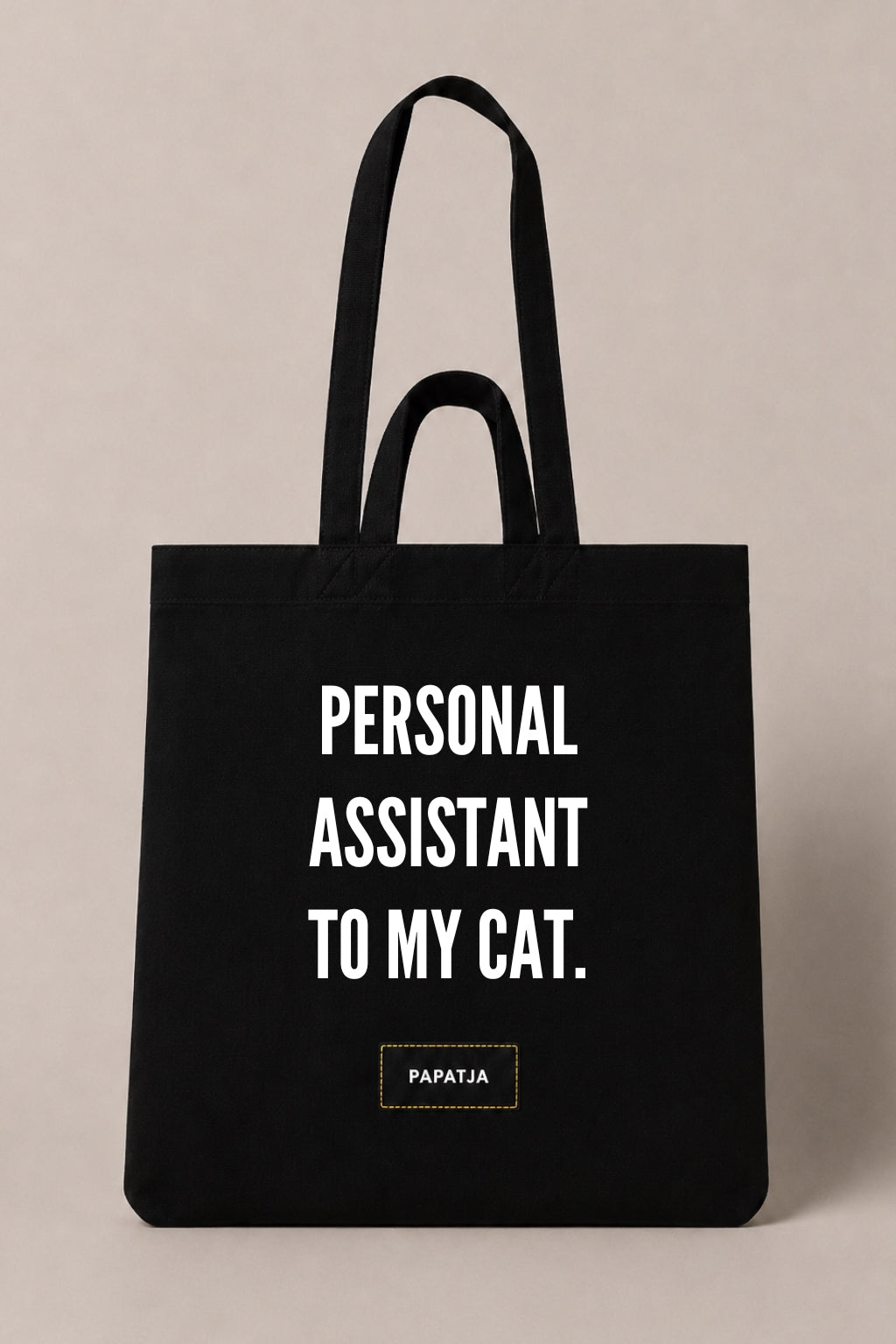 Black cotton PAPATJA tote bag with the quote Personal Assistant to My Cat, a funny gift for cat lovers.