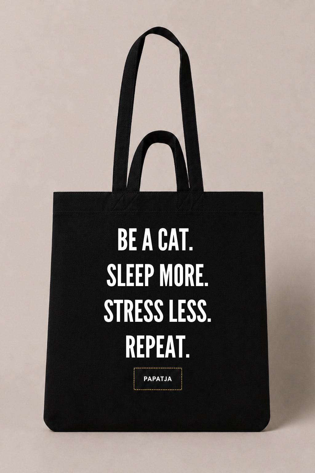 Black cotton PAPATJA tote bag with the quote Be a Cat. Sleep More. Stress Less. Repeat., a thoughtful gift for cat lovers.