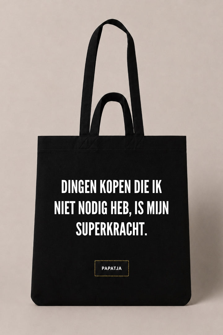 Zwarte katoenen PAPATJA tas met de tekst Dingen kopen die ik niet nodig heb, is mijn superkracht.