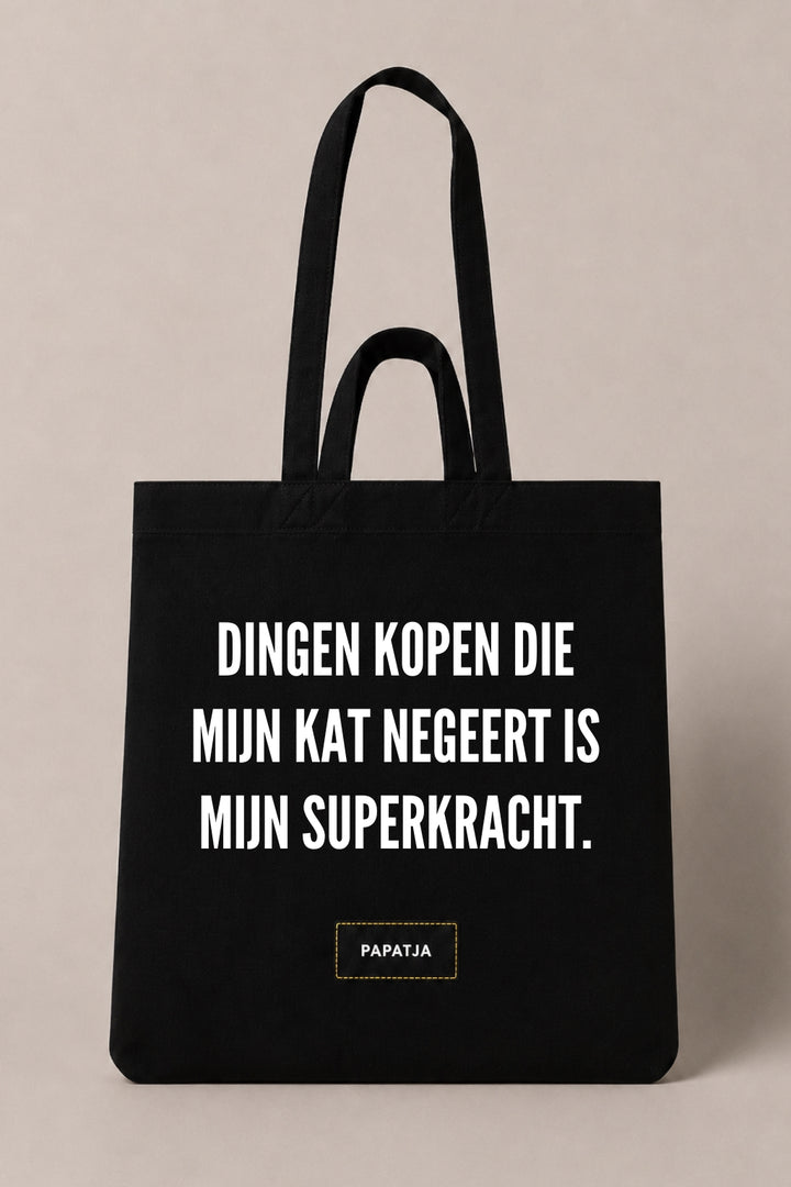 Zwarte katoenen PAPATJA tas met de tekst Dingen kopen die mijn kat negeert is mijn superkracht, leuk cadeau voor kattenliefhebbers met humor.