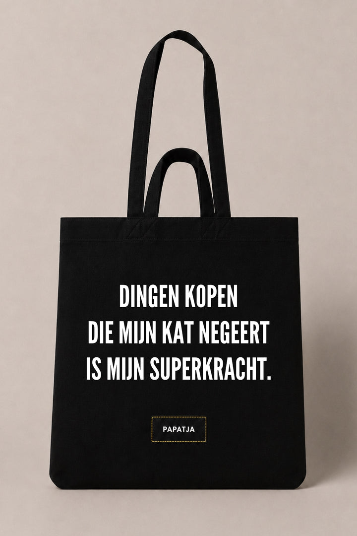 Zwarte katoenen PAPATJA tas met de tekst Dingen kopen die mijn kat negeert is mijn superkracht, leuk cadeau voor kattenliefhebbers met humor.